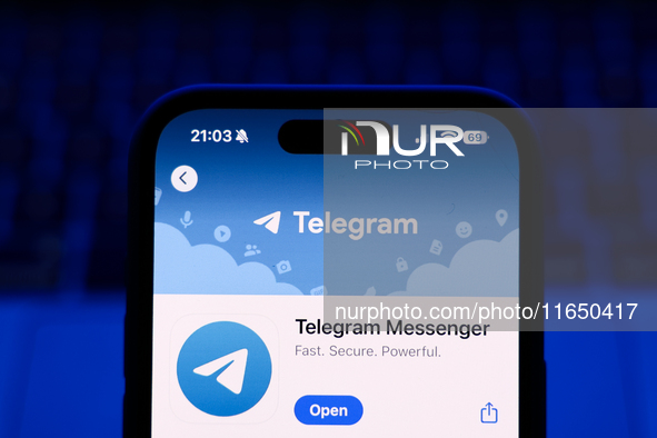 A laptop keyboard and Telegram on App Store displayed on a phone screen are seen in this illustration photo taken in Poland on October 8, 20...