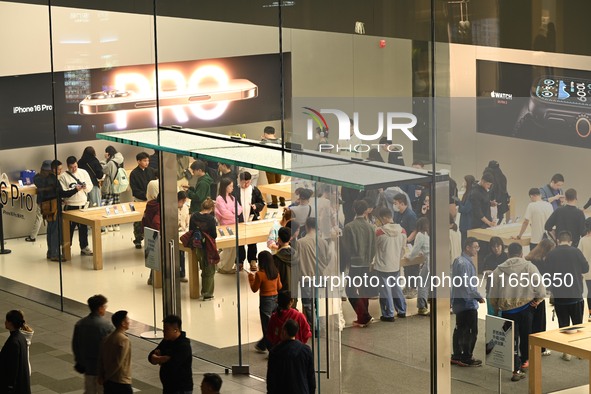 Customers experience Apple products at the Taikoo Li Apple Store in Chengdu, China, on October 8, 2024. 