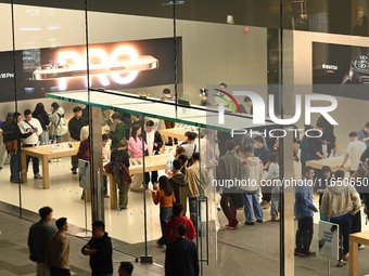 Customers experience Apple products at the Taikoo Li Apple Store in Chengdu, China, on October 8, 2024. (