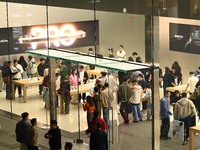 Customers experience Apple products at the Taikoo Li Apple Store in Chengdu, China, on October 8, 2024. (