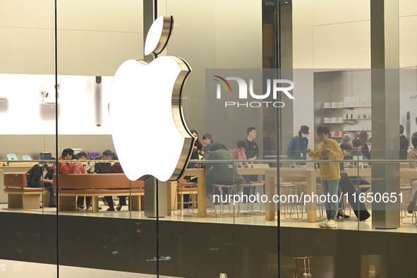 Customers experience Apple products at the Taikoo Li Apple Store in Chengdu, China, on October 8, 2024. 