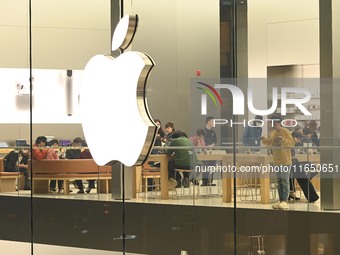 Customers experience Apple products at the Taikoo Li Apple Store in Chengdu, China, on October 8, 2024. (