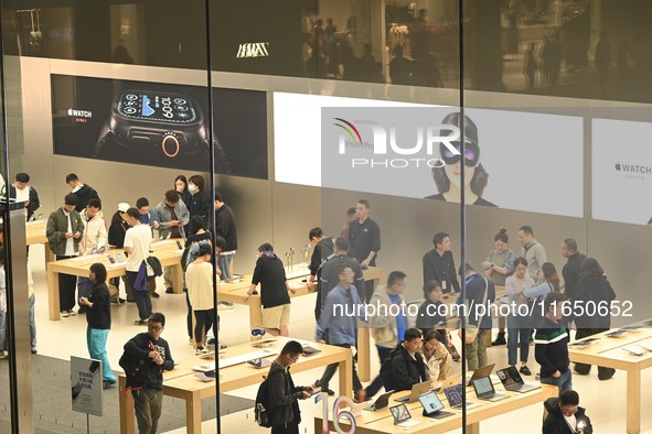 Customers experience Apple products at the Taikoo Li Apple Store in Chengdu, China, on October 8, 2024. 