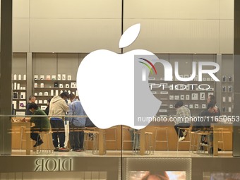 Customers experience Apple products at the Taikoo Li Apple Store in Chengdu, China, on October 8, 2024. (