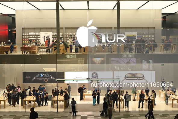 Customers experience Apple products at the Taikoo Li Apple Store in Chengdu, China, on October 8, 2024. 