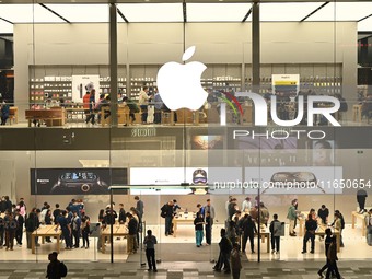 Customers experience Apple products at the Taikoo Li Apple Store in Chengdu, China, on October 8, 2024. (