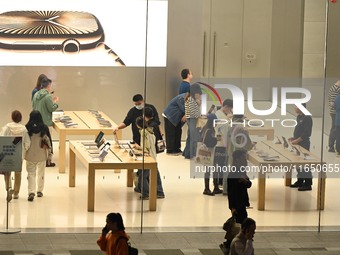 Customers experience Apple products at the Taikoo Li Apple Store in Chengdu, China, on October 8, 2024. (