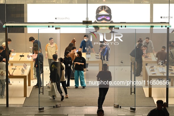 Customers experience Apple products at the Taikoo Li Apple Store in Chengdu, China, on October 8, 2024. 