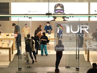 Customers experience Apple products at the Taikoo Li Apple Store in Chengdu, China, on October 8, 2024. (