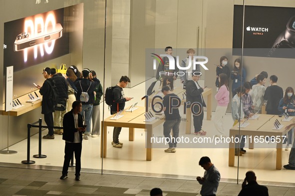 Customers experience Apple products at the Taikoo Li Apple Store in Chengdu, China, on October 8, 2024. 