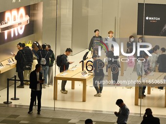 Customers experience Apple products at the Taikoo Li Apple Store in Chengdu, China, on October 8, 2024. (