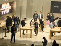 Customers experience Apple products at the Taikoo Li Apple Store in Chengdu, China, on October 8, 2024. (