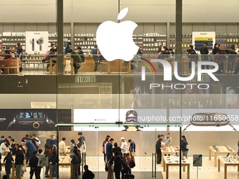 Customers experience Apple products at the Taikoo Li Apple Store in Chengdu, China, on October 8, 2024. (