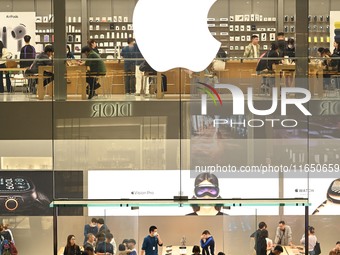 Customers experience Apple products at the Taikoo Li Apple Store in Chengdu, China, on October 8, 2024. (