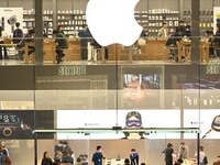 Customers experience Apple products at the Taikoo Li Apple Store in Chengdu, China, on October 8, 2024. (