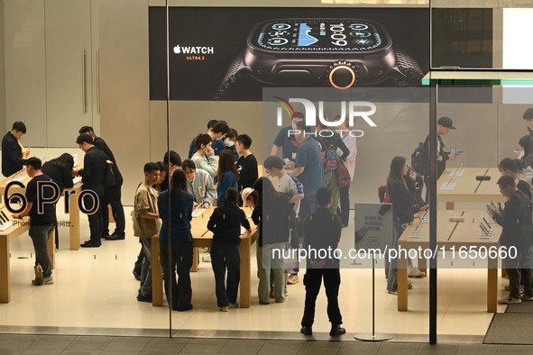 Customers experience Apple products at the Taikoo Li Apple Store in Chengdu, China, on October 8, 2024. 