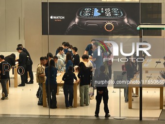 Customers experience Apple products at the Taikoo Li Apple Store in Chengdu, China, on October 8, 2024. (