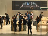 Customers experience Apple products at the Taikoo Li Apple Store in Chengdu, China, on October 8, 2024. (