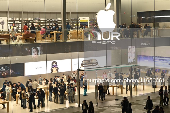 Customers experience Apple products at the Taikoo Li Apple Store in Chengdu, China, on October 8, 2024. 