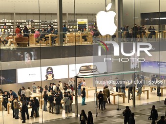 Customers experience Apple products at the Taikoo Li Apple Store in Chengdu, China, on October 8, 2024. (