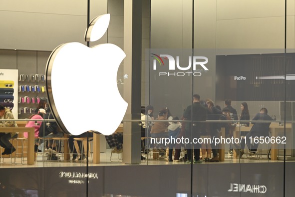 Customers experience Apple products at the Taikoo Li Apple Store in Chengdu, China, on October 8, 2024. 