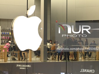 Customers experience Apple products at the Taikoo Li Apple Store in Chengdu, China, on October 8, 2024. (