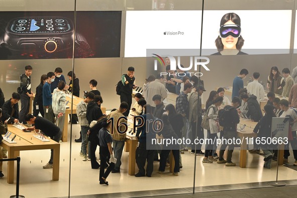 Customers experience Apple products at the Taikoo Li Apple Store in Chengdu, China, on October 8, 2024. 