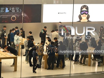 Customers experience Apple products at the Taikoo Li Apple Store in Chengdu, China, on October 8, 2024. (