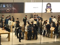 Customers experience Apple products at the Taikoo Li Apple Store in Chengdu, China, on October 8, 2024. (