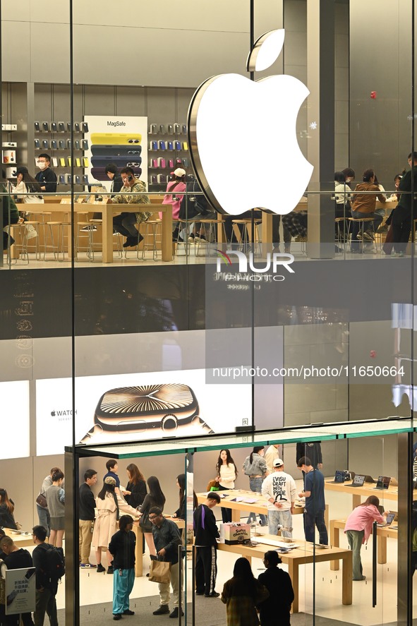 Customers experience Apple products at the Taikoo Li Apple Store in Chengdu, China, on October 8, 2024. 