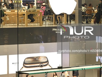 Customers experience Apple products at the Taikoo Li Apple Store in Chengdu, China, on October 8, 2024. (