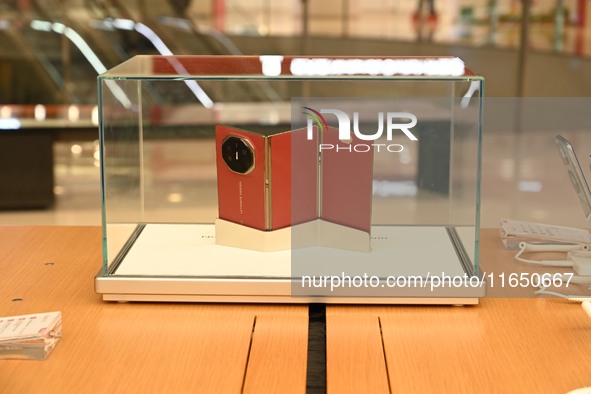 A Huawei Mate XT triple foldable screen mobile phone is displayed at a Huawei store located at IFS International Financial Center on Chunxi...