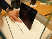 A Huawei Mate XT triple foldable screen mobile phone is displayed at a Huawei store located at IFS International Financial Center on Chunxi...