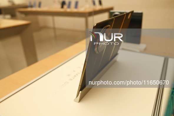 A Huawei Mate XT triple foldable screen mobile phone is displayed at a Huawei store located at IFS International Financial Center on Chunxi...