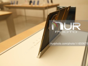 A Huawei Mate XT triple foldable screen mobile phone is displayed at a Huawei store located at IFS International Financial Center on Chunxi...