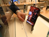 A Huawei Mate XT triple foldable screen mobile phone is displayed at a Huawei store located at IFS International Financial Center on Chunxi...