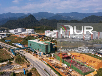 Workers work at the construction site of the 2024 help workshop in Congjiang County, Guizhou Province, China, on October 8, 2024. (