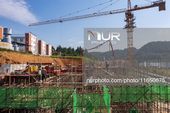 Workers work at the construction site of the 2024 help workshop in Congjiang County, Guizhou Province, China, on October 8, 2024. 