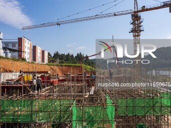 Workers work at the construction site of the 2024 help workshop in Congjiang County, Guizhou Province, China, on October 8, 2024. (