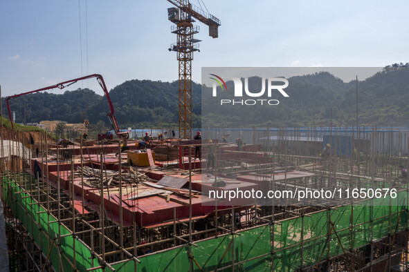 Workers work at the construction site of the 2024 help workshop in Congjiang County, Guizhou Province, China, on October 8, 2024. 