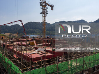 Workers work at the construction site of the 2024 help workshop in Congjiang County, Guizhou Province, China, on October 8, 2024. (