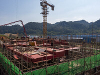 Workers work at the construction site of the 2024 help workshop in Congjiang County, Guizhou Province, China, on October 8, 2024. (