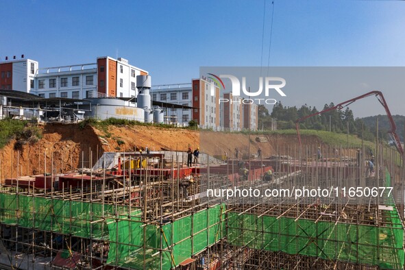 Workers work at the construction site of the 2024 help workshop in Congjiang County, Guizhou Province, China, on October 8, 2024. 