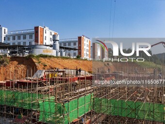 Workers work at the construction site of the 2024 help workshop in Congjiang County, Guizhou Province, China, on October 8, 2024. (