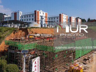 Workers work at the construction site of the 2024 help workshop in Congjiang County, Guizhou Province, China, on October 8, 2024. (