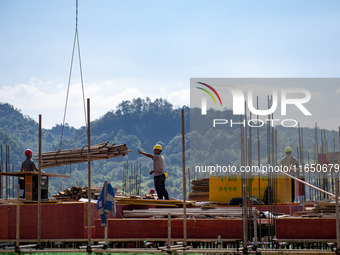 Workers work at the construction site of the 2024 help workshop in Congjiang County, Guizhou Province, China, on October 8, 2024. (