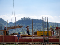 Workers work at the construction site of the 2024 help workshop in Congjiang County, Guizhou Province, China, on October 8, 2024. (