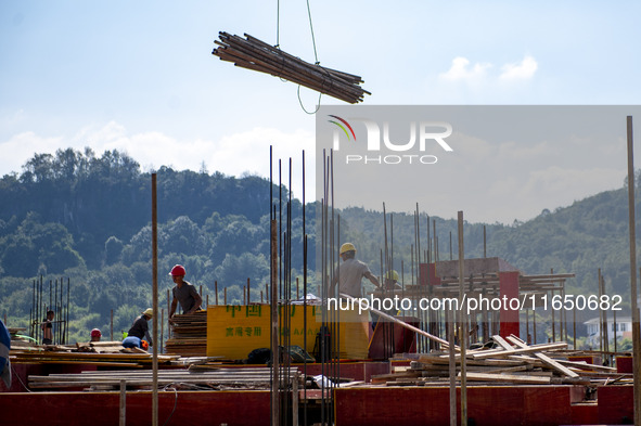 Workers work at the construction site of the 2024 help workshop in Congjiang County, Guizhou Province, China, on October 8, 2024. 