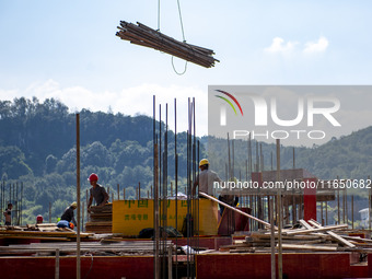 Workers work at the construction site of the 2024 help workshop in Congjiang County, Guizhou Province, China, on October 8, 2024. (