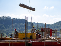 Workers work at the construction site of the 2024 help workshop in Congjiang County, Guizhou Province, China, on October 8, 2024. (